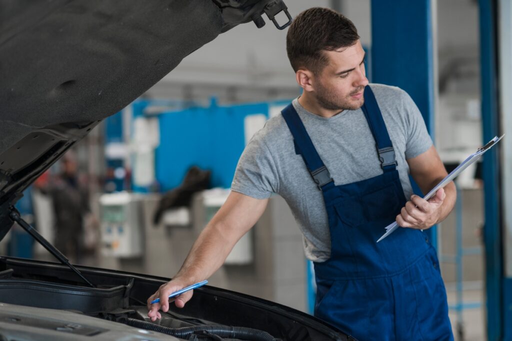 A mechanic inspecting the condition of the vehicle